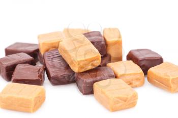 Heap of caramel candies on white background.