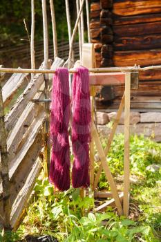 Pink yarn on wooden stick in the Norwegian Folk museum in Oslo.