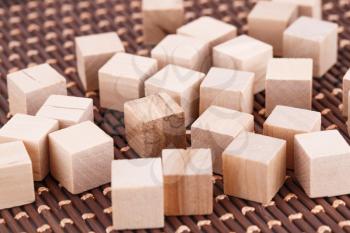 Wooden cubes on brown bamboo background.