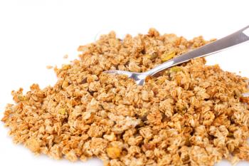 Heap of muesli with spoon on white background.