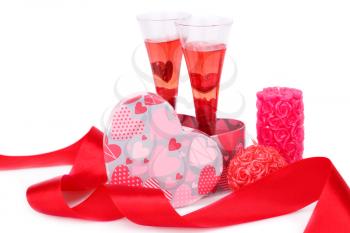 Two glasses with red candle, gift box and red ribbon isolated on white background.