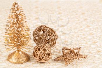 Christmas decoration with fir tree, wooden balls and star on the golden net.