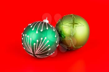 Christmas two green balls on red background.