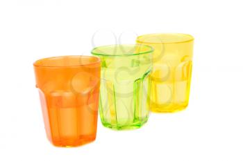 Colorful plastic glasses with water isolated on white background.