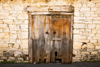 Old wooden brown door with chain in Limnatis village, Cyprus.