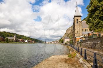 Houses and churches in Dinant, view from Meuse river in Belgium.