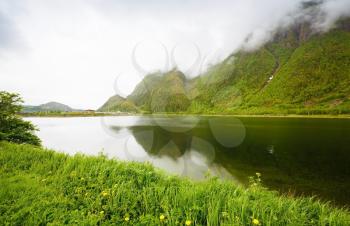 Landscape with high mountains and fjord in Mosjoen, Norway, foggy day.
