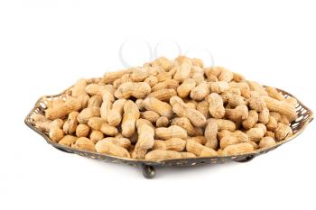Peanuts in shell in the metallic vintage vase isolated on white background.