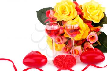Colorful roses, candles and ribbon on white background.