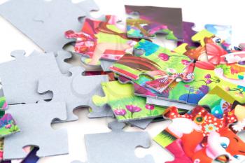 The pile of jigsaw puzzle pieces on white background.
