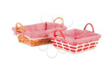 Two empty wicker baskets isolated on white background.