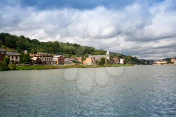 Houses and church in Dinant, view from Meuse river in Belgium.