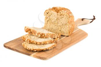 Wholegrain bread bun with oat on wooden board isolated on white background.
