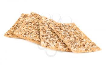 Pile of crackers with different seeds isolated on white background.