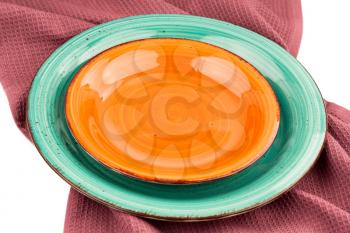 Two colorful empty plates on the cotton towel.