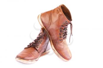 Brown stylish boots isolated on white background.