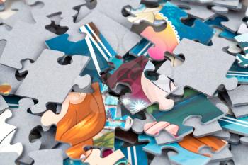The pile of jigsaw puzzle pieces close up picture.