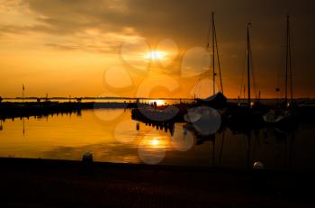 The boats at the sea harbour in the Dutch fisherman village Marken at the sunset.