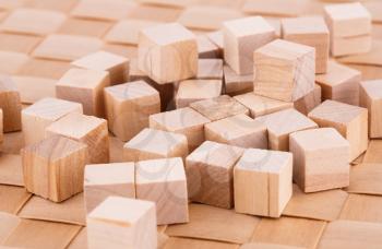 Wooden cubes on bamboo background.