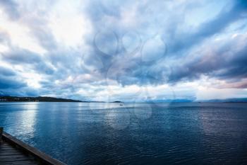 Landscape with sea and clouds in the midnight of polar day in Harstad, Norway.