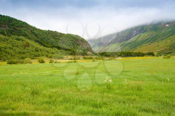 Landscape with mountains and meadow in Norway.