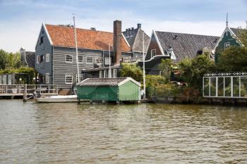 Traditional, authentic dutch houses and boat at the canal.