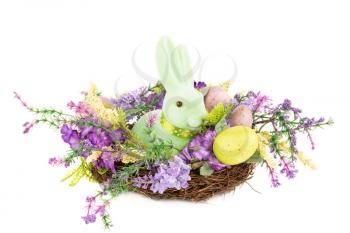 Easter colorful eggs and bunny in nest, flowers isolated on white background.