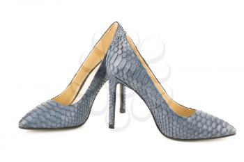 The pair of stylish high heels python leather shoes isolated on white background.