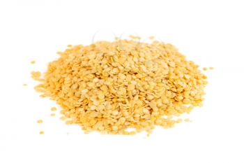 The heap of golden lentils isolated on a white background.