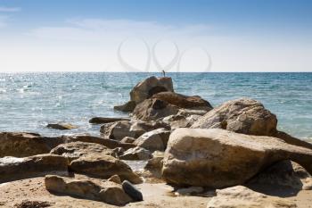 Blue Mediterranean sea with the sparkling surface and stones in Cyprus.