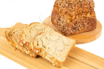Wholegrain bread bun with seeds and oat on wooden board on white background.