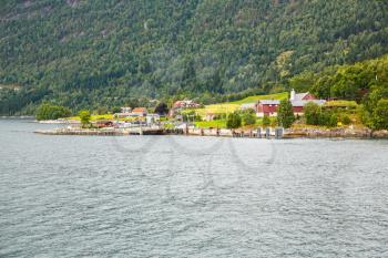 Landscapoe with mountains, village and fjord in Norway.