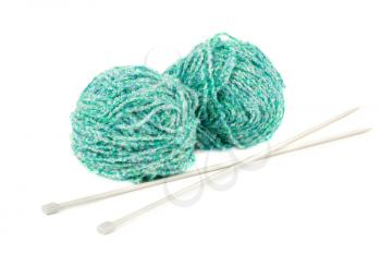 Two green knitting yarn clews and needles isolated on white background.