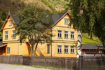 Yellow wooden house in the rural place in Norway.