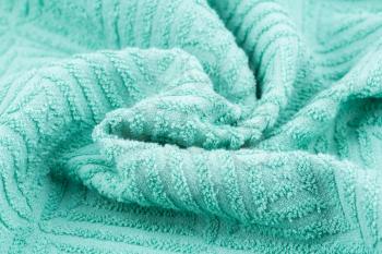 Green towel texture as a background, horizontal picture.