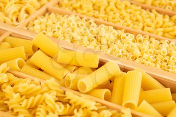 Various kind of Italian pasta in the wooden box.