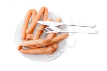 A fresh sausage on white plate with fork and knife. Isolated over white.