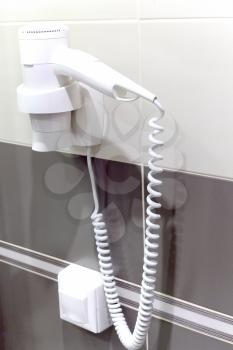 White  Hair Dryer on wall in bathroom. SPA