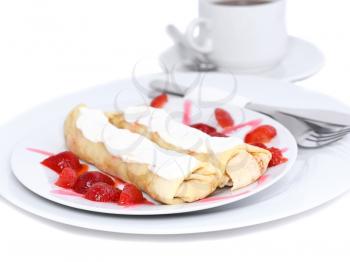 Pankcake with cream , with rolled fruit inside and strawberry around. Isolated