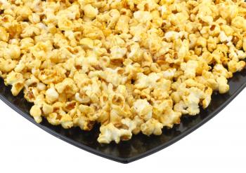 Fragment of plate with fresh caramel popcorn. Close-Up. Isolated