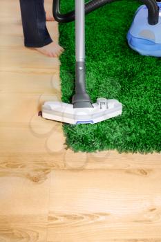 Vacuum cleaner in action  - a men cleaner a carpet. 