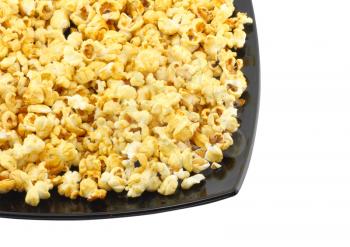 Fragment of plate with fresh caramel popcorn. Isolated