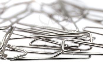 Lot of paper clips against a white background.Isolated