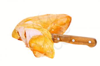 Slice on smoked chiken with knife . Isolated over white.
