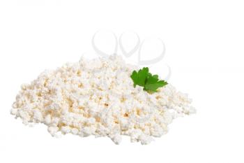 Fresh cottage cheese (curd) heap with parsley, isolated on white background.