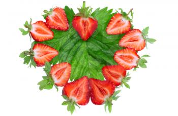 A fresh strawberries in heart shape on green foliage . Isolated