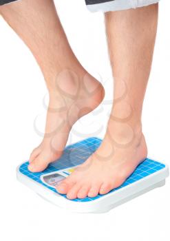Man's legs , which weighed on floor scale. Isolated over white