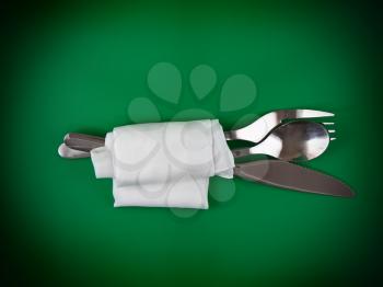 Table serving-knife,plate,fork and silk napkin  on  green colour background.
