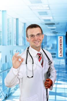 Friendly medical doctor stand in Hospital corridor, show OK!
