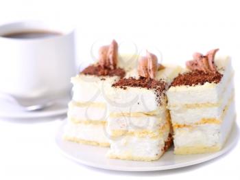 Sponge cakes with cup of coffee on plate with fruit-juice decoration . Isolated